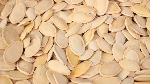 Pumpkin seeds seed looping texture pattern closeup video Stock Footage 99014781