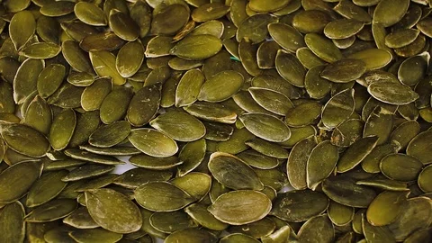 Pumpkin seeds seed looping texture pattern closeup video Stock Footage 99015328