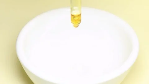 Pumpkin seeds with smoothie falling into a white bowl Stock Footage 333715519