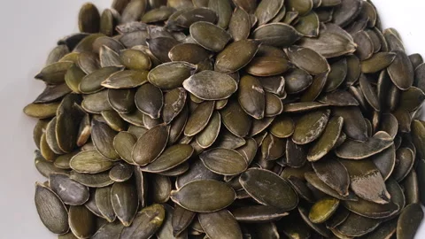 Pumpkin seeds turning in white ceramic bowl. Stock Footage 162597758