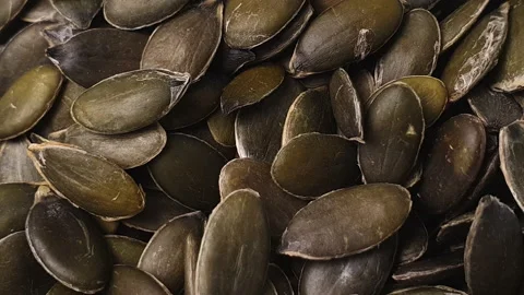 Pumpkin seeds turning in white ceramic bowl. Stock Footage 162598074
