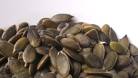 Pumpkin seeds turning in white ceramic bowl. Stock Footage 162598080