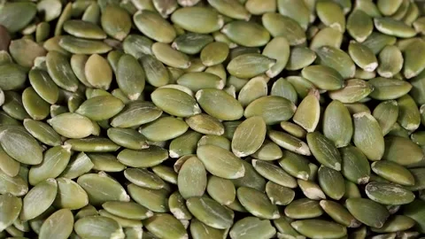 Pumpkin seeds on a turntable, close-up Stock Footage 157988846