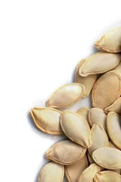 Pumpkin seeds on a white background. Close up Stock Photos