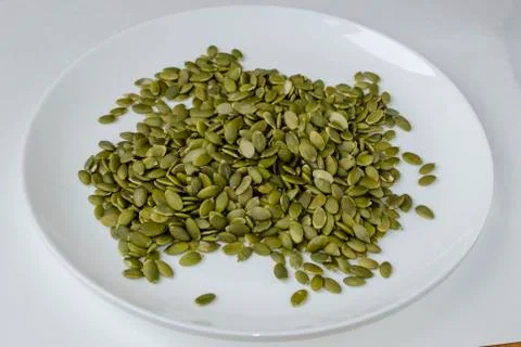 Pumpkin seeds on a white background Stock Photos