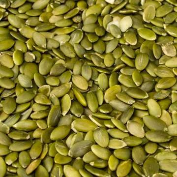 Pumpkin seeds on a white background Stock Photos