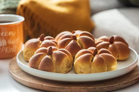 Pumpkin shaped bread rolls on white plate Stock Photos