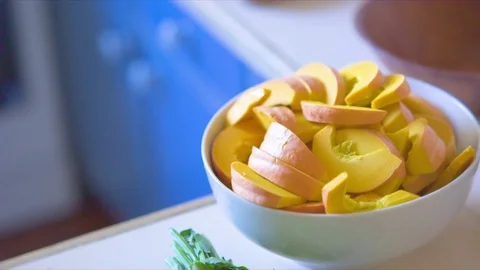 Pumpkin slice kept in bowl on kitchen worktop at home Video stock 76137259