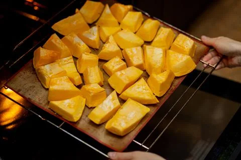 Pumpkin slices baked on a baking sheet in the oven. Homemade food Stock Photos