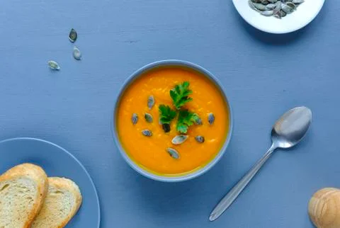 Pumpkin soup on blue table Stock Photos