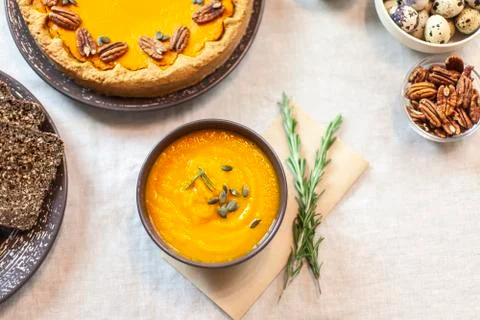 Pumpkin soup decorated on a table with a sprig of rosemary Stock-Fotos