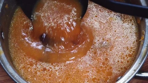 Pumpkin soup in a pan top view slow motion Video stock 127356723