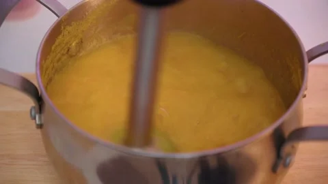 Pumpkin soup preparation, the process of making vegetable cream soup with a Stock Footage 235686438