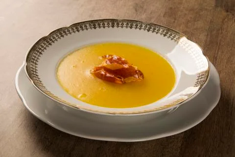Pumpkin Soup with proschiuto on table Stock Photos