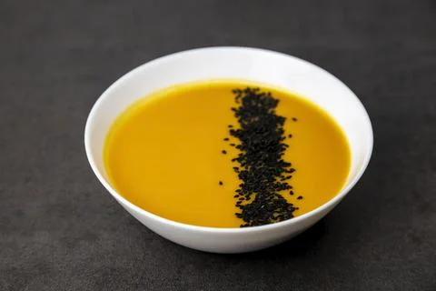 Pumpkin soup sprinkled with black sesame seeds. Healthy food. Stock Photos