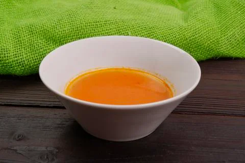 Pumpkin soup with tomatoes on a table Foto stock