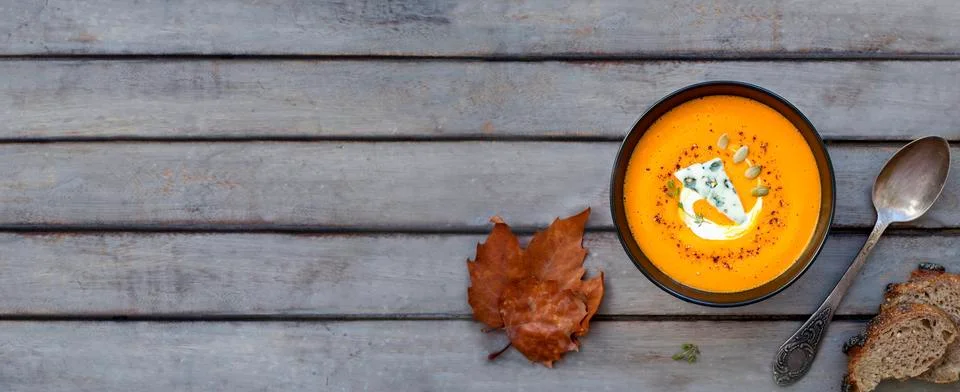 Pumpkin soup a wooden table. Stock Photos