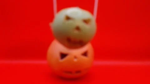 A pumpkin sways against a red background. 스톡 동영상 344455238