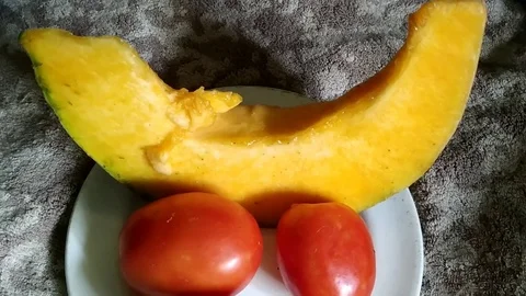 Pumpkin &amp; Tomatoes on Ceramic Plate Stock Footage 127104771