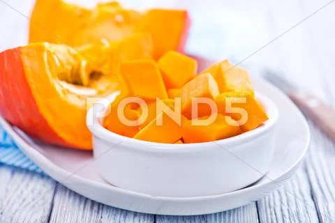 Pumpkin in white bowl on a table Stock Photos