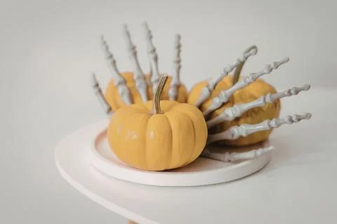 Pumpkin with white twisted branches on a white plate Stock Photos
