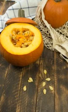 Pumpkin at the wooden table in the string bag shopper. Stock Photos