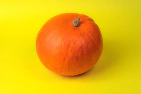 Pumpkin on yellow background close up Stock Photos