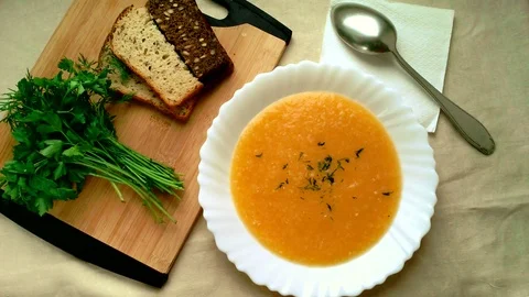 Pumpking soup with bread and hearbs Stock Footage 82770704