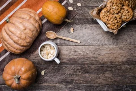 Pumpkins and cookies with nuts in rustic style Stock Photos