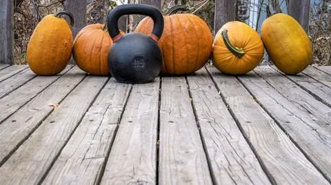 Pumpkins and kettlebell in backyard Stock Photos