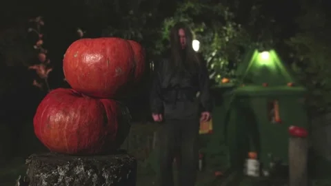 Pumpkins and a man in black. Видео 141707139