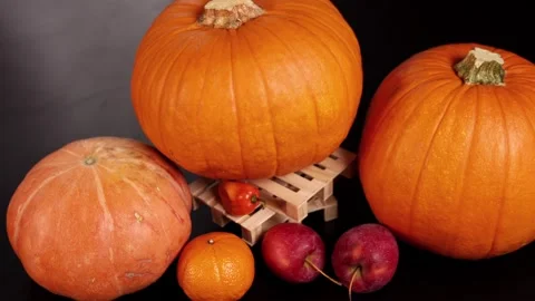 Pumpkins with apples, pepper evoke vibrant fall harvest atmosphere. Rustic Stock Footage 288362740