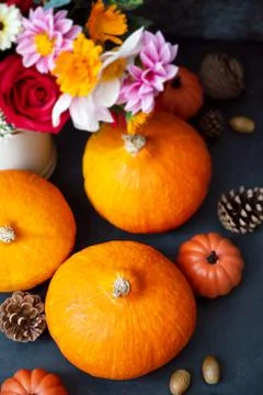 Pumpkins. Autumn creative flatlay, dark background with candles, autumn flowe Stock-Fotos