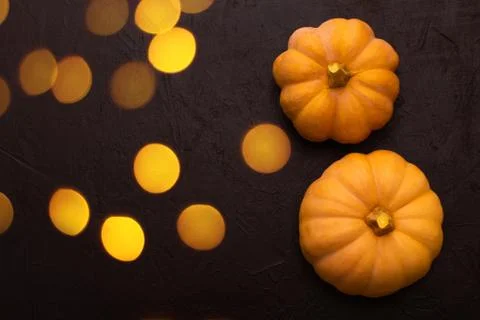 Pumpkins on black table with bokeh. Photos