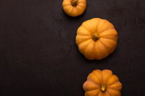 Pumpkins on black table. Halloween background Photos