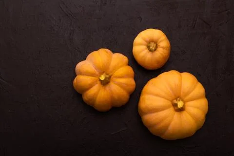 Pumpkins on black table. Halloween background Photos