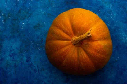 Pumpkins on blue table. Halloween background Фото