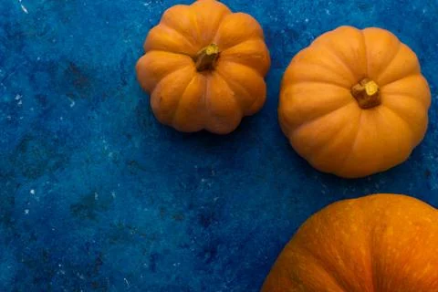 Pumpkins on blue table. Halloween background Stock Photos