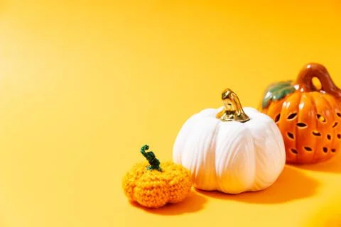 Pumpkins on bright yellow background with copy space for text Stock Photos
