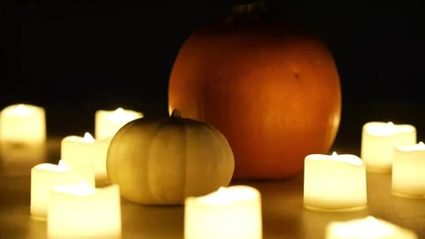 Pumpkins with candles flickering around them. Static shot. Halloween season Stock Footage 253829366