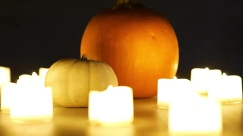Pumpkins with candles flickering around them. Static shot. Halloween season Stock Footage 253829367