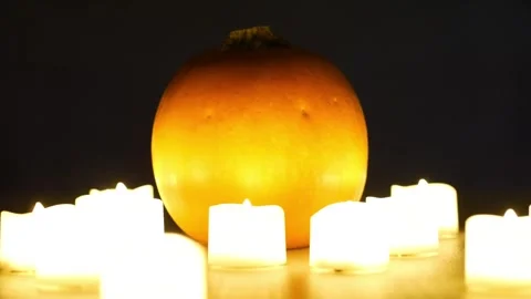 Pumpkins with candles flickering around them. Static shot. Halloween season Stock Footage 253829389