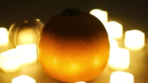 Pumpkins with candles flickering around them. Static shot. Halloween season Stock Footage 253829402