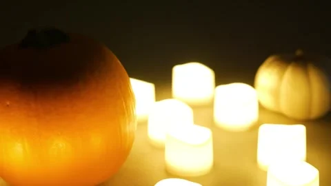 Pumpkins with candles flickering around them. Static shot. Halloween season 库存影片 253829406