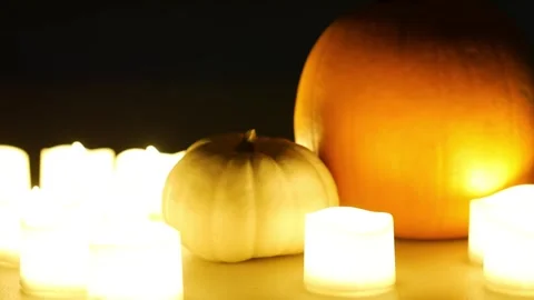 Pumpkins with candles flickering around them. Static shot. Halloween season Stock Footage 253829484
