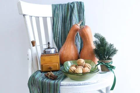 Pumpkins on a decorative tray, nuts, an old coffee grinder, decorative spru.. Stock Photos