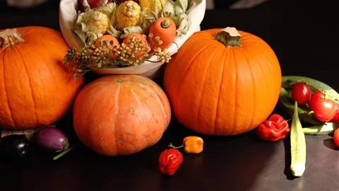 Pumpkins, eggplants, and corn create natural harvest scene perfect for rustic Stock Photos
