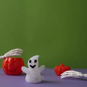 Pumpkins for Halloween with a ghost with hand bones. Stock Photos
