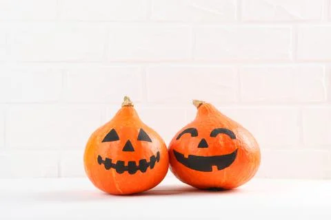 Pumpkins with painted faces on a colored background for Halloween. Stockfoto's