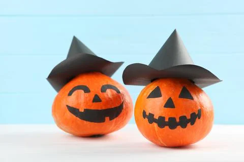 Pumpkins with painted faces on a colored background for Halloween. 写真素材